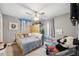 Comfortable bedroom with ceiling fan, soft carpet, natural light, and plenty of space for sleep and relaxation at 14545 Battenwood Dr, Spring Hill, FL 34610