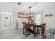 Bright dining room features a dark wood table, seating for six, and custom bar shelves at 14545 Battenwood Dr, Spring Hill, FL 34610