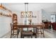Stylish dining room features a dark wood table, seating for six, and custom bar shelves at 14545 Battenwood Dr, Spring Hill, FL 34610