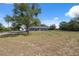 Well-maintained gray home with mature landscaping and a spacious front yard at 14545 Battenwood Dr, Spring Hill, FL 34610