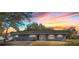 Charming exterior view of a single-story home with a well-manicured lawn and beautiful sunset in the background at 14545 Battenwood Dr, Spring Hill, FL 34610