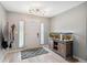 Bright foyer with a decorative front door, modern light fixture, wood-look floors, and a statement aquarium at 14545 Battenwood Dr, Spring Hill, FL 34610