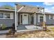 Inviting front porch with a covered entrance, neutral paint, decorative plants, and a cozy seating area at 14545 Battenwood Dr, Spring Hill, FL 34610