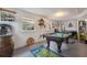 Game room featuring pool table, decor, two windows for natural light, and access to other areas of the home at 14545 Battenwood Dr, Spring Hill, FL 34610