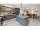Modern kitchen with gray cabinets, granite island, and view to dining room at 14545 Battenwood Dr, Spring Hill, FL 34610