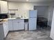 Bright kitchenette with modern appliances and white cabinetry for a clean look at 14545 Battenwood Dr, Spring Hill, FL 34610