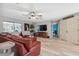 Comfortable living room featuring stylish furniture, an entertainment center, and lots of natural light at 14545 Battenwood Dr, Spring Hill, FL 34610