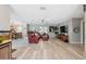 Spacious living room with an open layout, wood-look floors, comfortable seating, and a seamless flow at 14545 Battenwood Dr, Spring Hill, FL 34610
