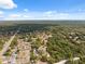 An aerial shot shows a peaceful neighborhood surrounded by lush greenery and quiet streets at 14545 Battenwood Dr, Spring Hill, FL 34610