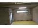 Unfinished basement area with concrete block walls, exposed ceiling, and sliding door at 1514 Citrine Trl, Tarpon Springs, FL 34689
