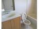 Bathroom featuring a vanity, toilet, and tub-shower combination with tile surround at 1514 Citrine Trl, Tarpon Springs, FL 34689