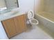Bathroom featuring a sink, toilet, vanity, and tub, offering essential amenities and a clean aesthetic at 1514 Citrine Trl, Tarpon Springs, FL 34689