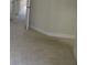 Hallway with carpeted floors and neutral walls, creating a transition space within the home at 1514 Citrine Trl, Tarpon Springs, FL 34689