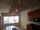 The kitchen has dark counters, light wood cabinets and an island with sink at 1514 Citrine Trl, Tarpon Springs, FL 34689