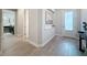 Hallway showcasing wood floors, neutral walls, and access to the laundry room at 15355 Renaissance Ave, Odessa, FL 33556