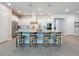 Modern kitchen with an island, pendant lighting, stainless steel appliances, and seating for four at 15355 Renaissance Ave, Odessa, FL 33556