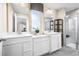 Bathroom with dual sinks, quartz countertop and walk in shower at 20334 Lou Angela Ln, Lutz, FL 33558