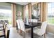 Dining room with view to the outdoors, modern lighting and elegant table setting at 20334 Lou Angela Ln, Lutz, FL 33558