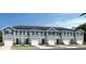 New townhouse with white trim, blue shutters, and single car garage at 20334 Lou Angela Ln, Lutz, FL 33558