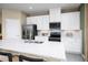 Bright kitchen featuring stainless appliances, pendant lighting, and bar seating at 20334 Lou Angela Ln, Lutz, FL 33558