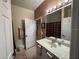 This bathroom has a single sink, a large mirror, and white cabinets at 21008 Sunpoint Way # 204, Lutz, FL 33558