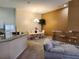 Open-concept dining area with elegant chandelier, breakfast bar, and a view of the adjacent kitchen at 21008 Sunpoint Way # 204, Lutz, FL 33558