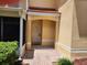 Charming condo entrance featuring brick pavers, and a covered porch with a red tile roof, offering a welcoming first impression at 21008 Sunpoint Way # 204, Lutz, FL 33558