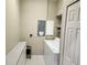 Functional laundry room with white washer and dryer, cabinets, and tiled flooring at 21008 Sunpoint Way # 204, Lutz, FL 33558