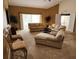 Spacious living room with neutral carpet, ample seating, and sliding glass doors to the outdoor patio area at 21008 Sunpoint Way # 204, Lutz, FL 33558