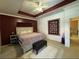 Spacious bedroom features tray ceilings, decorative wall art, and en-suite bathroom at 21008 Sunpoint Way # 204, Lutz, FL 33558