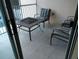Cozy patio with cushioned seating and a fire pit, perfect for outdoor gatherings at 21008 Sunpoint Way # 204, Lutz, FL 33558