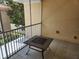 A patio with a metal table and railings overlooking some greenery at 21008 Sunpoint Way # 204, Lutz, FL 33558