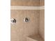 Shower area featuring neutral tile, accent border, chrome fixtures, and a built-in seat for a comfortable experience at 21008 Sunpoint Way # 204, Lutz, FL 33558
