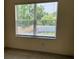 Comfortable bedroom featuring a window with blinds offering natural light at 21041 Sunpoint Way # 202, Lutz, FL 33558