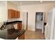 Functional kitchen with a granite countertop, white appliances, and ample cabinet space at 21041 Sunpoint Way # 202, Lutz, FL 33558
