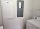 Functional laundry area features standard washer, dryer hookups, and utility panel at 21041 Sunpoint Way # 202, Lutz, FL 33558