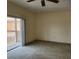 Cozy living room with balcony access, carpet floors, and ample natural light at 21041 Sunpoint Way # 202, Lutz, FL 33558