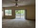 Open living space featuring a ceiling fan, balcony access, and bright windows for a refreshing view at 21041 Sunpoint Way # 202, Lutz, FL 33558
