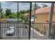 Screened balcony view of the community with parking and colorful buildings at 21041 Sunpoint Way # 202, Lutz, FL 33558