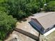 Aerial view of the backyard with a wooden fence and mature trees offering plenty of privacy at 2660 Orangewood Ct, Palm Harbor, FL 34684