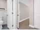 Bathroom with marble tiling, open doorway and toilet at 2660 Orangewood Ct, Palm Harbor, FL 34684