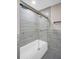 Modern bathroom featuring glass enclosed tub, a shower head and tiled walls for a clean and contemporary look at 2660 Orangewood Ct, Palm Harbor, FL 34684