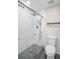 Updated bathroom highlighting glass shower with grey stone base and a toilet at 2660 Orangewood Ct, Palm Harbor, FL 34684