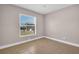 Neutral bedroom features a window with outdoor views and tiled flooring, creating a versatile and inviting space at 2660 Orangewood Ct, Palm Harbor, FL 34684