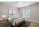 Relaxing bedroom features a window view, neutral walls, area rug and a ceiling fan at 2660 Orangewood Ct, Palm Harbor, FL 34684