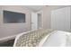 Cozy bedroom featuring a large window and closet with a tv mounted on the wall at 2660 Orangewood Ct, Palm Harbor, FL 34684