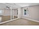 Bright bedroom featuring ceramic tile flooring, neutral paint, and a large mirrored closet at 2660 Orangewood Ct, Palm Harbor, FL 34684
