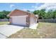 Home exterior featuring a stone accent and two car garage at 2660 Orangewood Ct, Palm Harbor, FL 34684