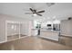 Modern kitchen with stainless steel appliances, white cabinetry, granite countertops, and a center island at 2660 Orangewood Ct, Palm Harbor, FL 34684
