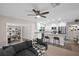 Open-concept living room flows into a modern kitchen with stainless steel appliances and a center island at 2660 Orangewood Ct, Palm Harbor, FL 34684